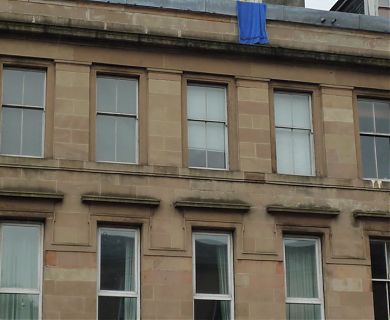 Towel hanging from top flat at 527 Great Western Road, Glasgow.