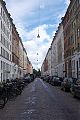 street in Copenhagen, flanked with cars and bikes